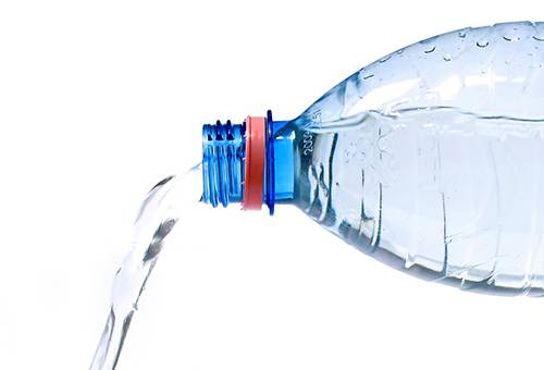 Вода се излива от бутилка