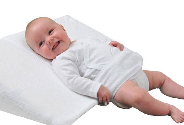 Eğimli bir yastık üzerinde bebek