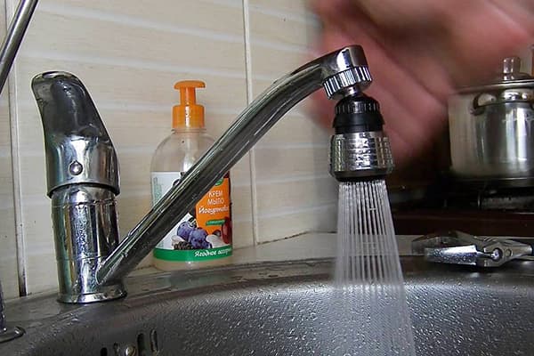Spraying water nozzle on the faucet in the kitchen